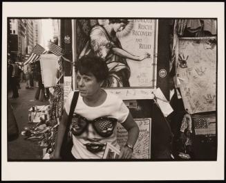 Woman standing in front of tribute posters, World Trade Center, New York City, USA