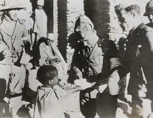A little Ethiopian native gets his injured arm bandaged by an Italian army doctor after Mussolini's men captured Aduwa, November 6, 1935
