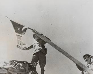 Symbolic of their victory, Italian soldiers raised the flag of the homeland on the ramparts of Aduwa as their generals claimed the newly won territory in the name of Italy, November 6, 1935