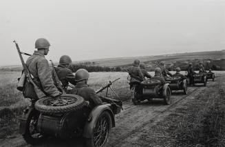 Troops on the move in three-man motorcycle sidecars (commanded by Battalion Commisar E. Khaimov)