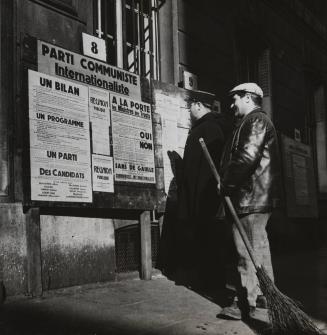 The police officer and sweeper are reading the posters of the International Communist Party, Paris, France/ Voter in front of an election propaganda billboard for the "Parti Communiste Internationaliste"/ Elections to the Constituent National Assembly and Referendum (rejection of a first draft constitution), Paris, France, October 21, 1945
