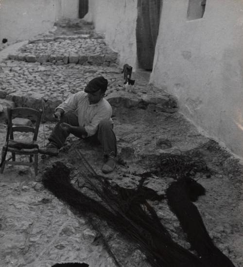 Fisherman mending his nets, Ibiza, Balearic Islands, Spain August 1955