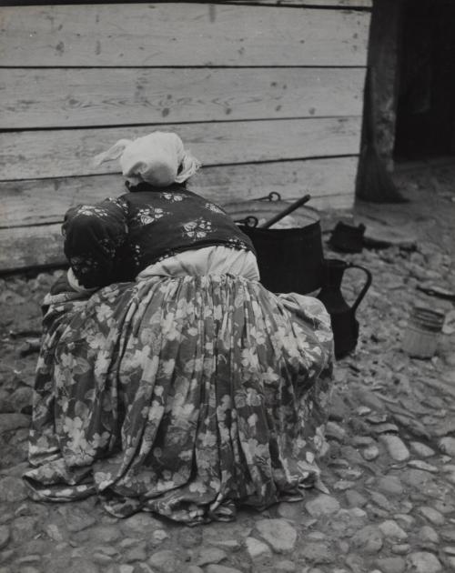 Untitled [Woman cooking on cobblestone street], Tirana, Albania