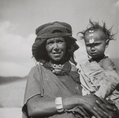 Mother carrying child from a village in the Dades Valley, Morocco