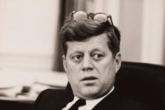 President John F. Kennedy with glasses on his head