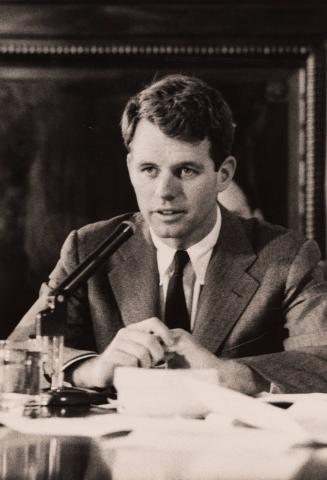 Bobby Kennedy speaking into a microphone