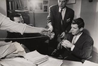 Bobby Kennedy watching men measure his desk