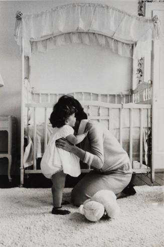 Jackie Kennedy hugging daughter Caroline in their Georgetown home nursery