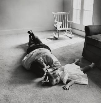 Ted Kennedy lying on floor with daughter, Kara, at home in Boston