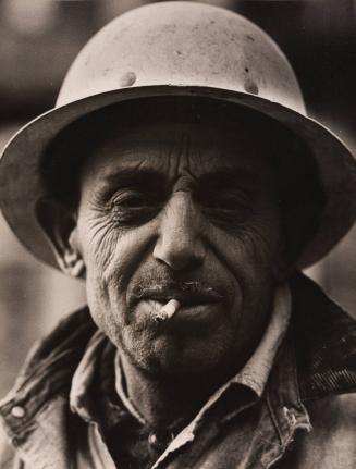 Portrait of construction worker in hard hat with cigarette in mouth
