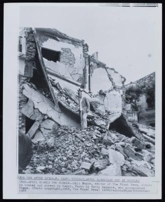 Amid The Rubble: Bill Baggs, editor of The Miami News, stands in bombed out-street in Hanoi. Photo by Harry Ashmore, who accompanied Baggs, April 9, 1968