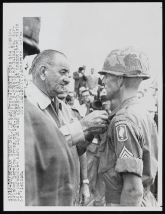 President Johnson pins the Distinguished Service Cross on Sergeant Charles B. Morris, of Galax, Virginia during ceremonies here October 26th, 1966, when Johnson paid an unannounced visit to Vietnam