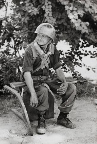 The Struggle For Cambodia: Portrait of a Cambodian soldier; old before his time he sits slumped in a posture of abject dejection; he has witnessed the utter devastation of his country