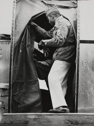 Sgt. 1.C. Ezell McKinnon of Fitzsimons checks inside of plane to determine how many wounded are ambulatory and how many will have to be carried on stretchers, December 1967