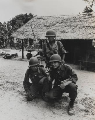 Vietnam Troops On Patrol: A Republic of Vietnam Army commander uses a portable radio to keep in contact with his unit outside the village. The unit is constantly on patrol to hunt down Viet Cong rebels, May 1962