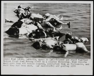 Trussed and roped together bodies float down Mekong river in a cluster. News reports said more than 400 bodies counted, identified them as Vietnamese, and said they had been shot, April 1970