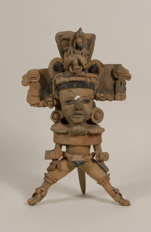 [Standing figure wearing headdress]