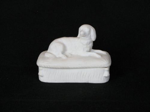 [Lidded parian box with reclining dog on cushion]