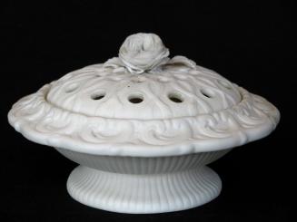 [Parian crocus jar with applied rose, decorative holes in lid, low relief veining and mottling and low relief fluting on bowl and foot]