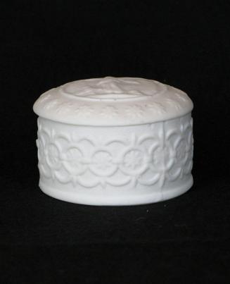 [Round, lidded parian trinket box, with high relief classical figure motif within circle, floral decoration on lid and high relief quatre-foil design and background mottling on box]