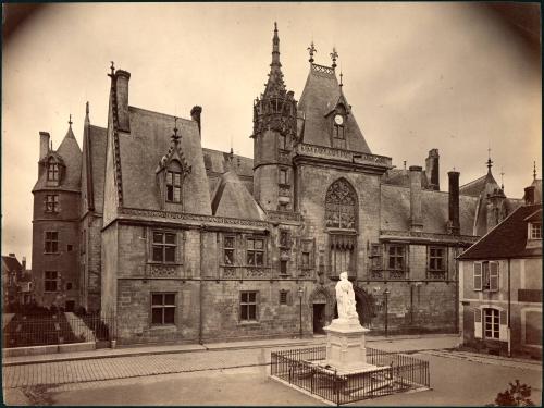 untitled [view of cathedral, ruin, statue of woman, iron fence]