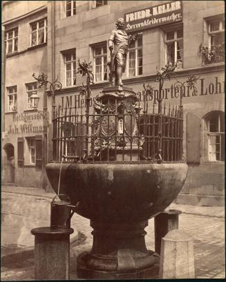 [Fountain with fence around basin, figure reading a book]