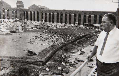 Oswald Surveys Cluttered Prisonyard