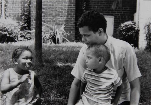 Julian Bond sits with children in front yard, Detroit, July 1969