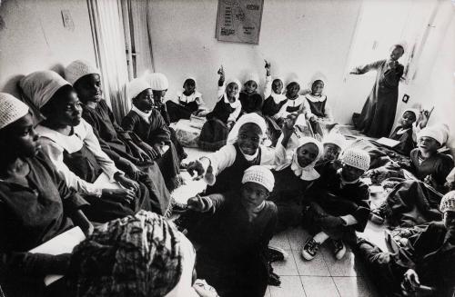 Black Hebrew kids crowded in room of an apartment where they study, Dimona, Israel