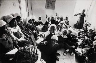 Black Hebrew kids crowded in room of an apartment where they study, Dimona, Israel