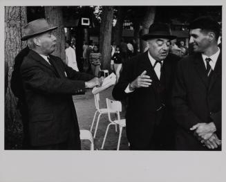 Men talking in park, Deauville, France