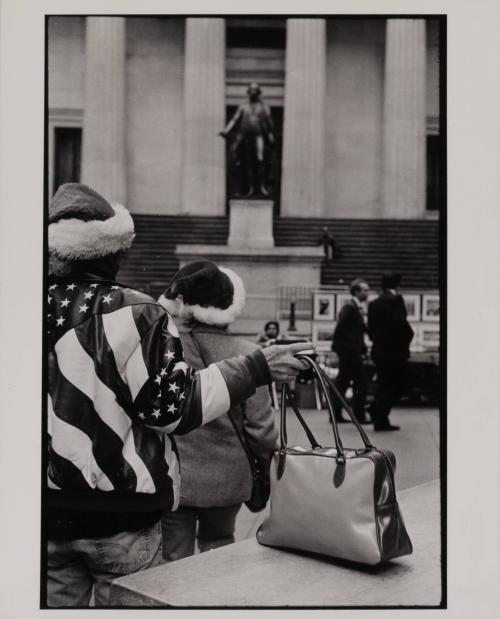 Two people with flag jackets and Santa hats, New York City, USA