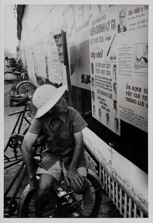 Shots of candidate posters in downtown Saigon with local citizens in various degrees of interest, 1967