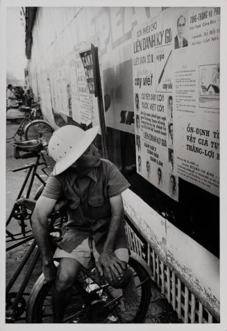 Shots of candidate posters in downtown Saigon with local citizens in various degrees of interest, 1967