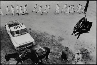 Guns are passed to the picket tower; the line returns from work