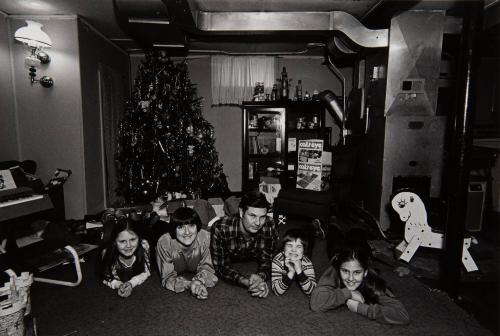 Christmas, A policeman, his family and a neighborhood friend in the basement playroom of their house