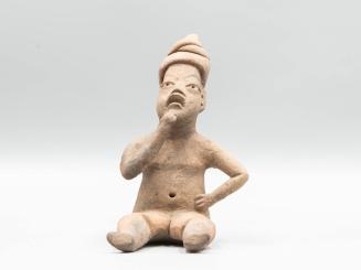 [Seated figure]
