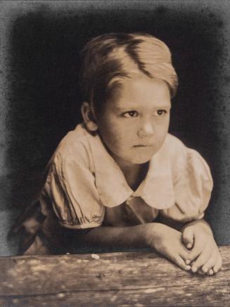 Portrait of Wanda Scroggs leaning on log windowsill, Brasstown, North Carolina