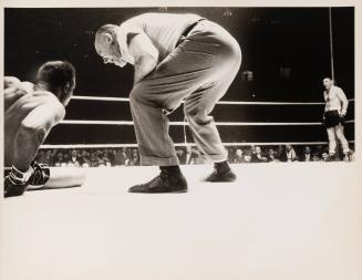 [Archie Moore, Yvon Durelle, and referee in boxing ring]
