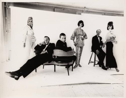 [Bill Blass, John Weitz, and John Moore seated with models standing by]
