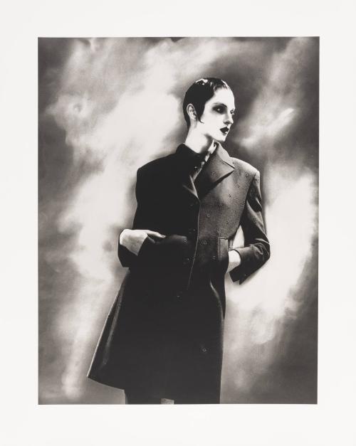 [Woman posing in long coat]