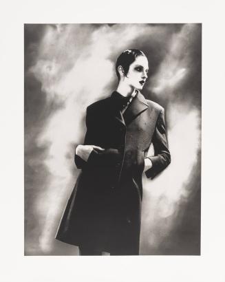 [Woman posing in long coat]