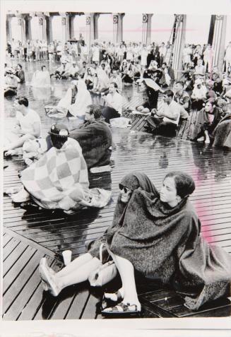 A rainstorm Wednesday failed to drive off the civil rights demonstrators who have been marching and demonstrating outside the Democratic national convention at Atlantic City's Convention hall. When the rain started, they huddled under blankets on the Boardwalk in an attempt to keep dry.