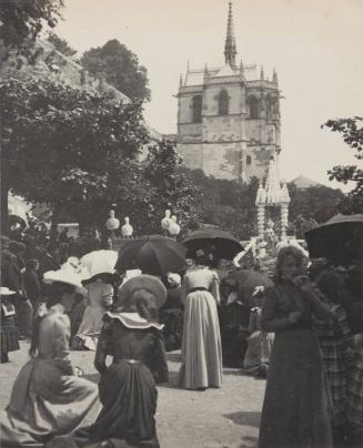 [Crowd with spired building in the background]