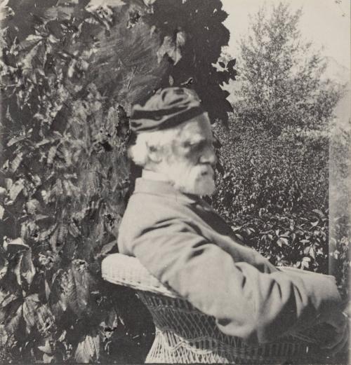 [Side profile of older man sitting in chair]