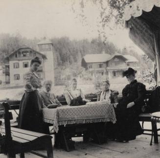 [Group portrait at an outdoor table]