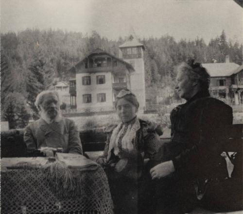 [Three people seated together at table]