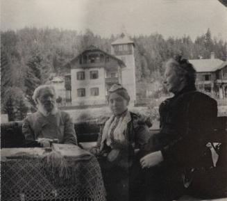 [Three people seated together at table]