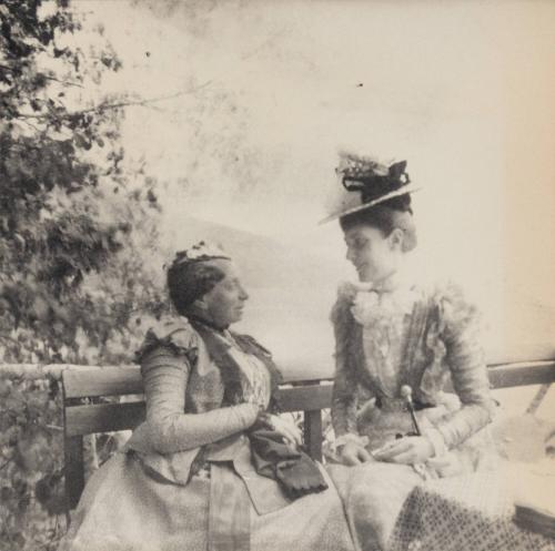 [Two women seated together]