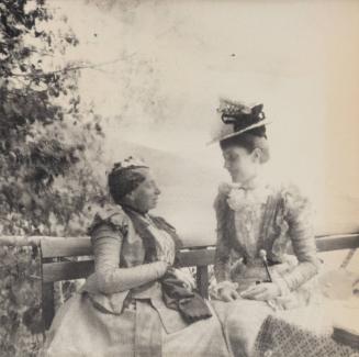 [Two women seated together]